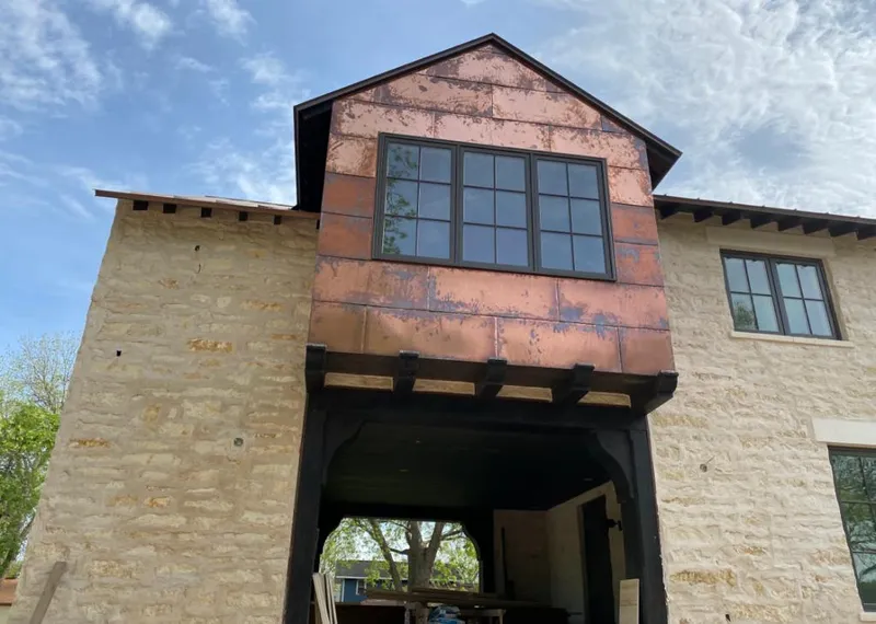 Copper metal panel facade on a stone building for Skylight Installation in Oakmont